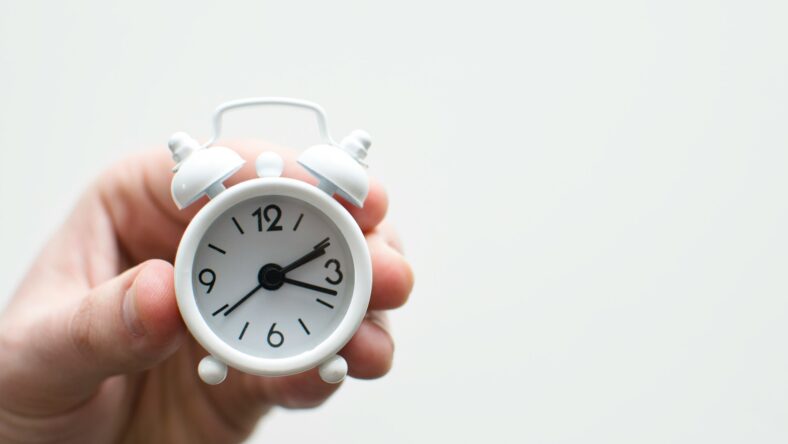 hand holding tiny clock